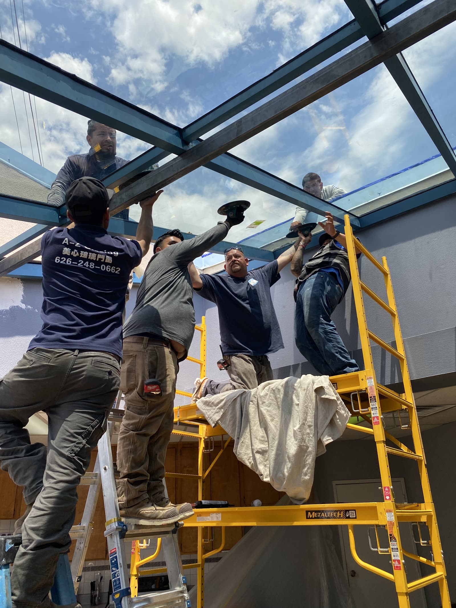AZ Glazing crew installing overhead glass framing in Los Angeles